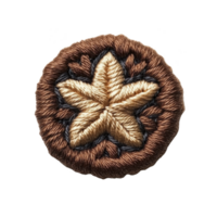 A round embroidered patch features central star design in shades of brown and beige, surrounded by intricate patterns. craftsmanship highlights detailed stitching, creating textured appearance png