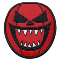 A This features round, red embroidered patch with menacing face design. face has sharp, triangular eyes and wide, toothy grin, creating intimidating expression. patch is outlined black png