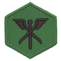 This shows green hexagonal patch with design featuring crossed tools and wings, symbolizing mechanics or engineering. patch has stitched border, giving it rugged appearance png