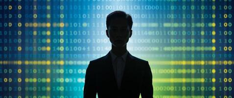 A man in a suit stands in front of a binary code photo