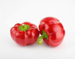 Two ripe red bell peppers isolated on white background perfect for healthy recipes and cooking photo