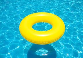 An inflatable yellow ring floating in a pool photo