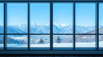 A spacious, modern office with a large window overlooking a snowy mountain range. photo