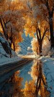 Autumn trees frame a snowy road reflecting vibrant orange leaves in the serene landscape at dusk photo