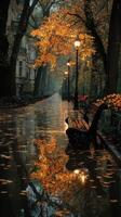 Autumn leaves blanket a tranquil park path lined with lampposts and reflections in puddles during an overcast day photo