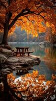 Serene picnic spot by the lake surrounded by vibrant autumn foliage in the early morning light photo