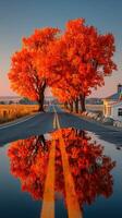 Scenic autumnal road with vibrant orange trees and reflection on water, captured in the golden hour photo