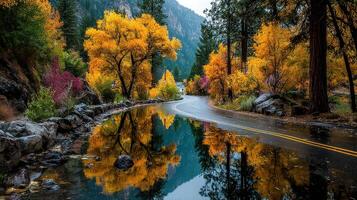 Autumn colors reflect on a winding road in a tranquil mountain landscape during a serene evening photo