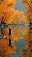 Woman capturing autumn reflections by a tranquil river surrounded by vivid orange trees photo