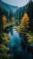 A serene river flows through a vibrant autumn forest showcasing golden trees and reflective water photo