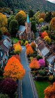 Vibrant autumn colors illuminate a quaint village street with historic church in the background photo