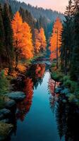 Autumn landscape with vibrant orange trees reflecting in calm river at sunrise near forest photo