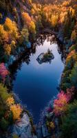 Autumn colors reflect on a serene lake with an island in the center during sunset in a wooded area photo