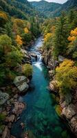 Beautiful waterfall surrounded by colorful autumn foliage flowing through rocky terrain in a serene forest setting photo