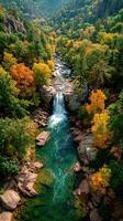 Stunning waterfall surrounded by vibrant autumn foliage in a serene mountain landscape photo