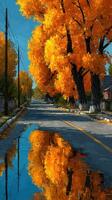 Colorful autumn trees line a quiet street reflecting vibrant orange hues in a serene setting photo