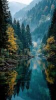 Serene river surrounded by autumn foliage and misty mountains during early morning hours photo