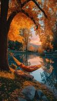 Relaxing in a hammock by a serene lake surrounded by vibrant autumn foliage at sunset photo