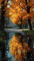 Vibrant autumn leaves reflect in calm water beside a winding path in a serene park setting photo