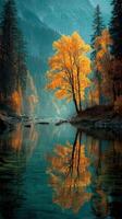 Stunning autumn reflection of a golden tree by a tranquil river in the mountains during a peaceful morning photo