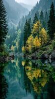 Autumn foliage and misty mountains reflected in a tranquil river at dawn photo