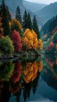 Vibrant autumn colors reflect on calm water in a serene forest landscape during early morning light photo