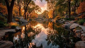 Autumn sunset casting golden reflections over the tranquil pond in Central Park photo
