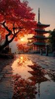 Tranquil sunset at a traditional pagoda surrounded by vibrant autumn foliage and calm reflections photo