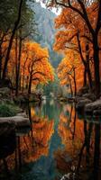 Colorful autumn landscape with golden trees by a serene river in a mountainous region during a tranquil morning photo