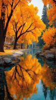 Vibrant autumn trees reflecting on a tranquil river in a scenic park location photo