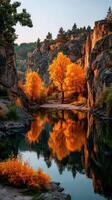 Colorful autumn trees reflect in serene river surrounded by rocky cliffs at sunrise photo