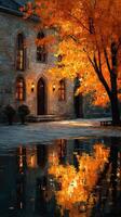Autumn colors reflect in water near a historic stone building with warm lights photo