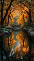 Majestic autumn colors reflect in tranquil waters under a historic bridge in a serene park photo
