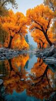 Brilliant autumn colors reflected in a serene river surrounded by golden trees in a tranquil landscape photo