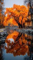 Stunning autumn trees reflect in calm water by a quaint building in a serene countryside setting photo