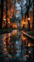 Beautiful autumn park at dusk with orange foliage and reflections in the water photo