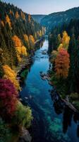 Beautiful autumn landscape with a winding river surrounded by colorful trees in the mountains at sunrise photo