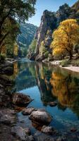 Autumn reflections in a tranquil river surrounded by rocky cliffs and vibrant trees photo