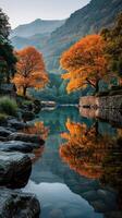Serene autumn landscape with vibrant orange trees reflecting in calm river at sunrise photo