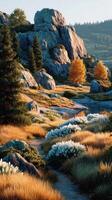 Majestic autumn landscape with rocky hills, vibrant foliage, and a serene stream at sunset photo