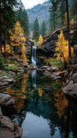 Beautiful autumn landscape with colorful trees and tranquil waterfall reflecting in still water photo