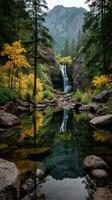 Waterfall cascading through autumn foliage in peaceful natural setting by serene pond photo