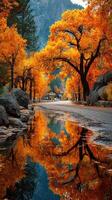 Autumn landscape with vibrant orange trees and a reflecting pond near a scenic road at sunset photo