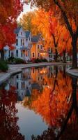 Fall colors reflect on a tranquil canal in a charming neighborhood, showcasing vibrant trees and cozy houses during sunset photo