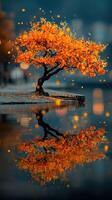 Vibrant autumn tree reflects on still water surface at sunset in a tranquil outdoor setting photo