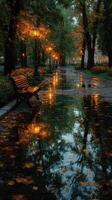 Serene autumn evening in a park with glowing streetlights and reflections on a rain-soaked path photo