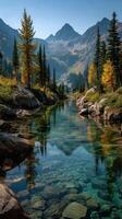 Breathtaking mountain landscape with a clear river and vibrant autumn colors in the foreground photo