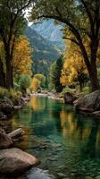 Autumn colors reflecting in a tranquil river surrounded by rocky landscapes in a mountainous region photo
