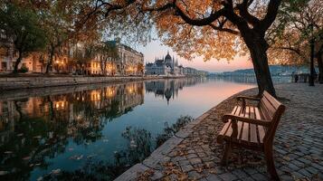 Beautiful autumn sunset by the river in Budapest with trees and historic buildings reflecting on the water photo