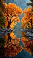 Vibrant autumn foliage reflects on a calm river surrounded by majestic mountains in a tranquil natural setting photo